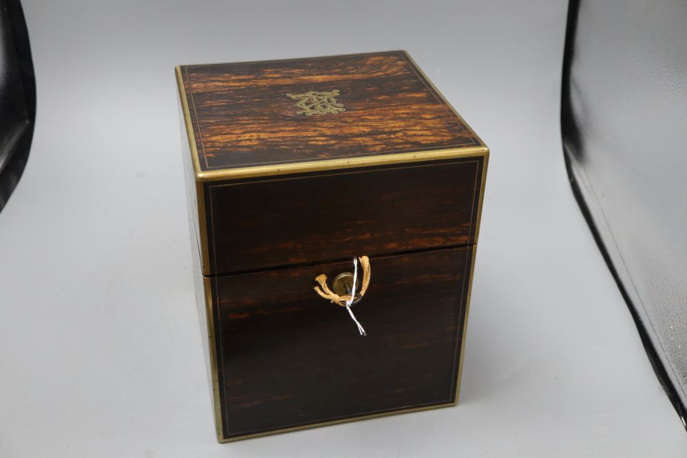 An early Victorian coromandel and brass bound four division decanter box, the lid inset with monogram, enclosing three decanters, heigh